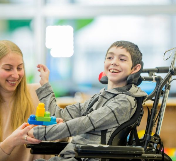 a care giver from direct caregiving services in UK attending to a disabled child
