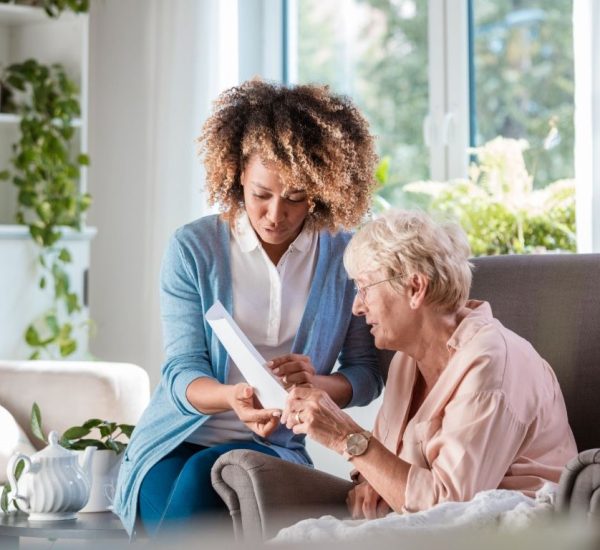 a direct care giving carer attending to an elderly lady at home